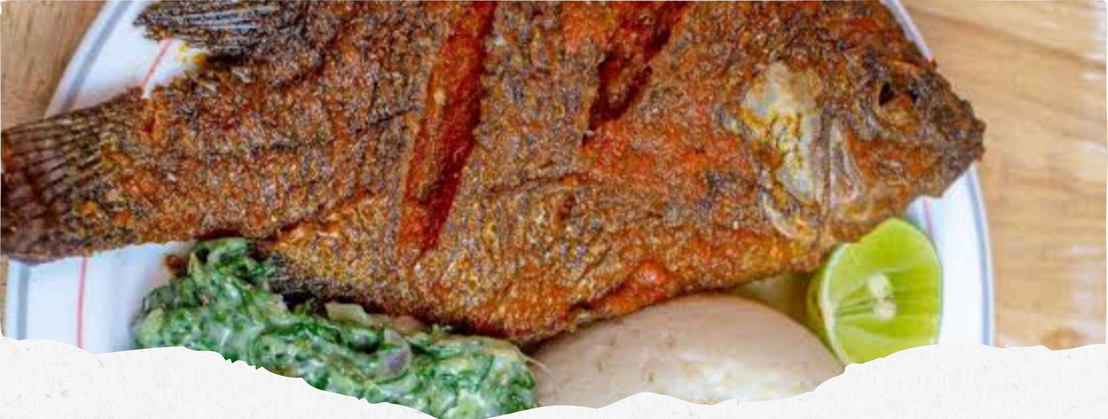 Fried tilapia served with greens and lime at Legacy Lounge